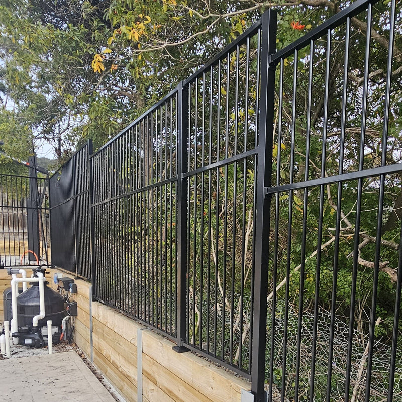 Black aluminium flat top pool fence panels installed in a backyard